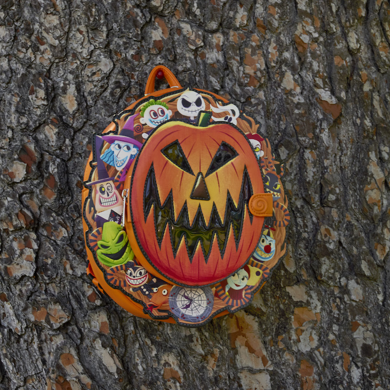 Image of the Nightmare Before Christmas Cameo Mini Backpack against a tree, with the front flap closed. 