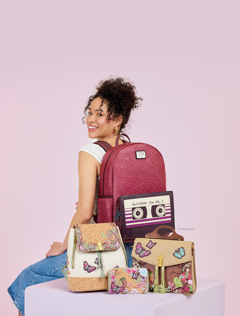 Pink background with model showcasing Loungefly May Guardians of the Galaxy Groot collection