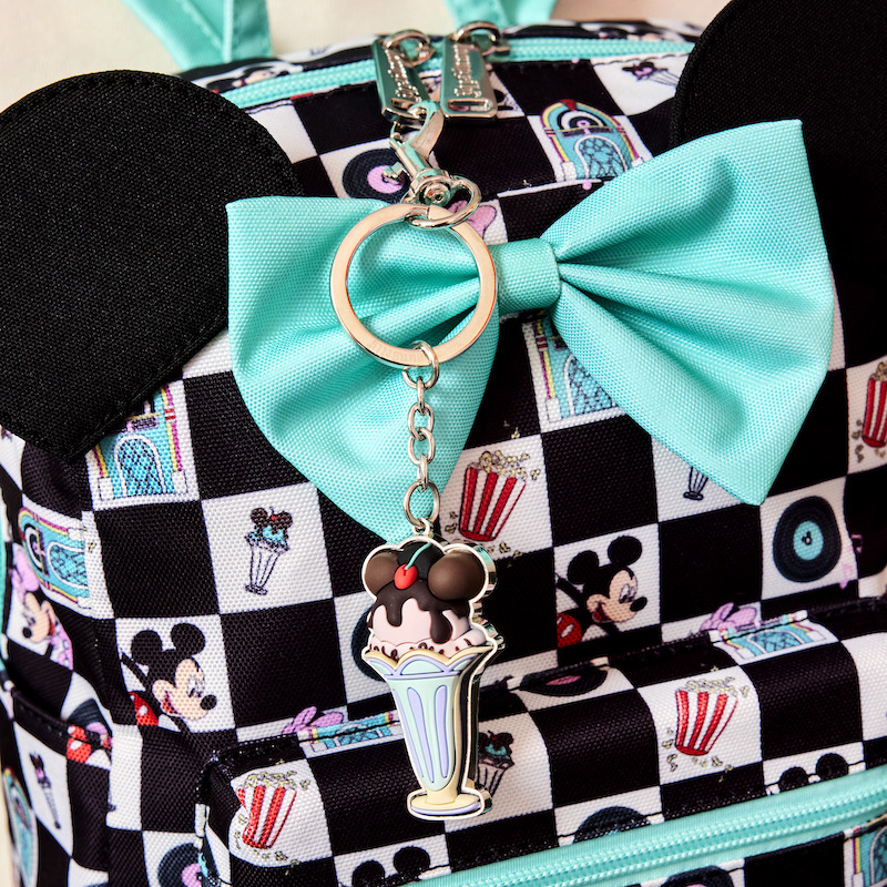Image of the Mickey and Minnie Date Night Nylon mini backpack with the ice cream keychain attached to it 