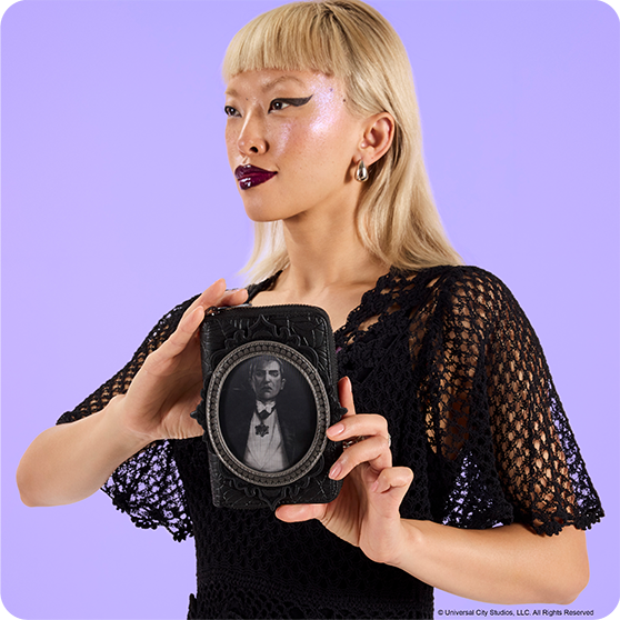 Purple background with model showcasing Loungefly Universal Monsters wallet