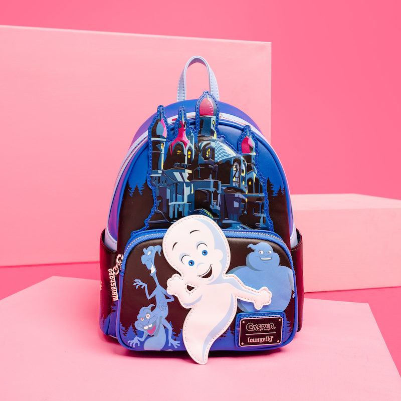 Loungefly mini backpack featuring Casper the Friendly Ghost and other ghosts in front of Whipstaff Manor. The bag sits against a two-toned pink background. 