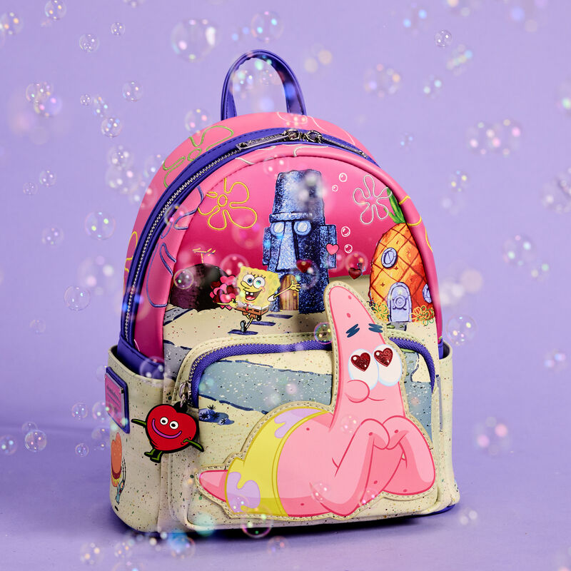 Loungefly mini backpack featuring Patrick as an applique on the front pocket, laying on his stomach and making heart eyes to the sky. Behind him, you’ll find SpongeBob waving with valentines in his hands as he walks around their Bikini Bottom neighborhood. The bag sits against a purple background surrounded by bubbles. 