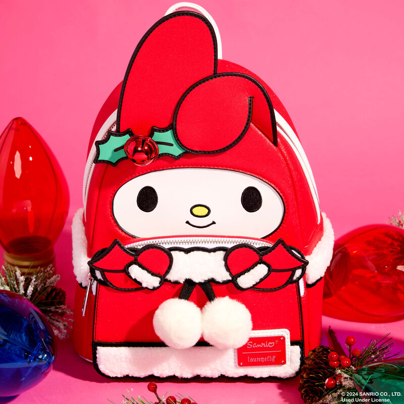 Loungefly mini backpack featuring Sanrio's My Melody in a red and white holiday outfit. The bag sits against a light red/pink background surrounded by large holiday lights. 