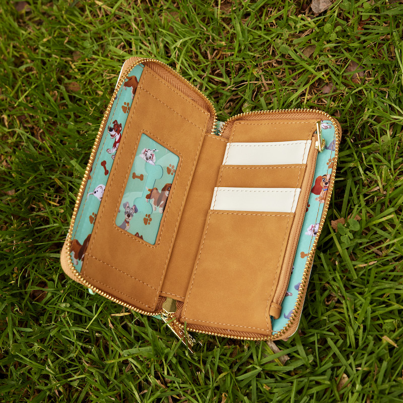 Image of our I Heart Disney Dogs Zip Around Wallet sitting outside in the grass open to show the card slots 