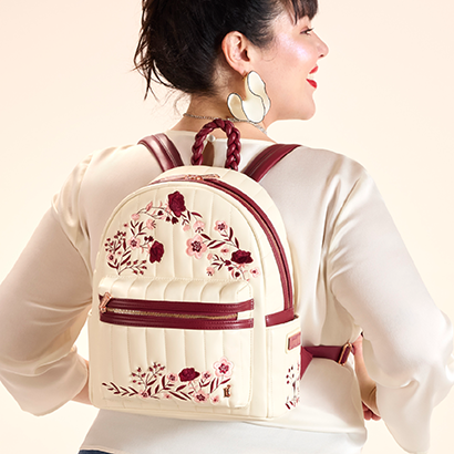 Tan background with model showcasing Loungefly Branded Cream Floral Mini Backpack
