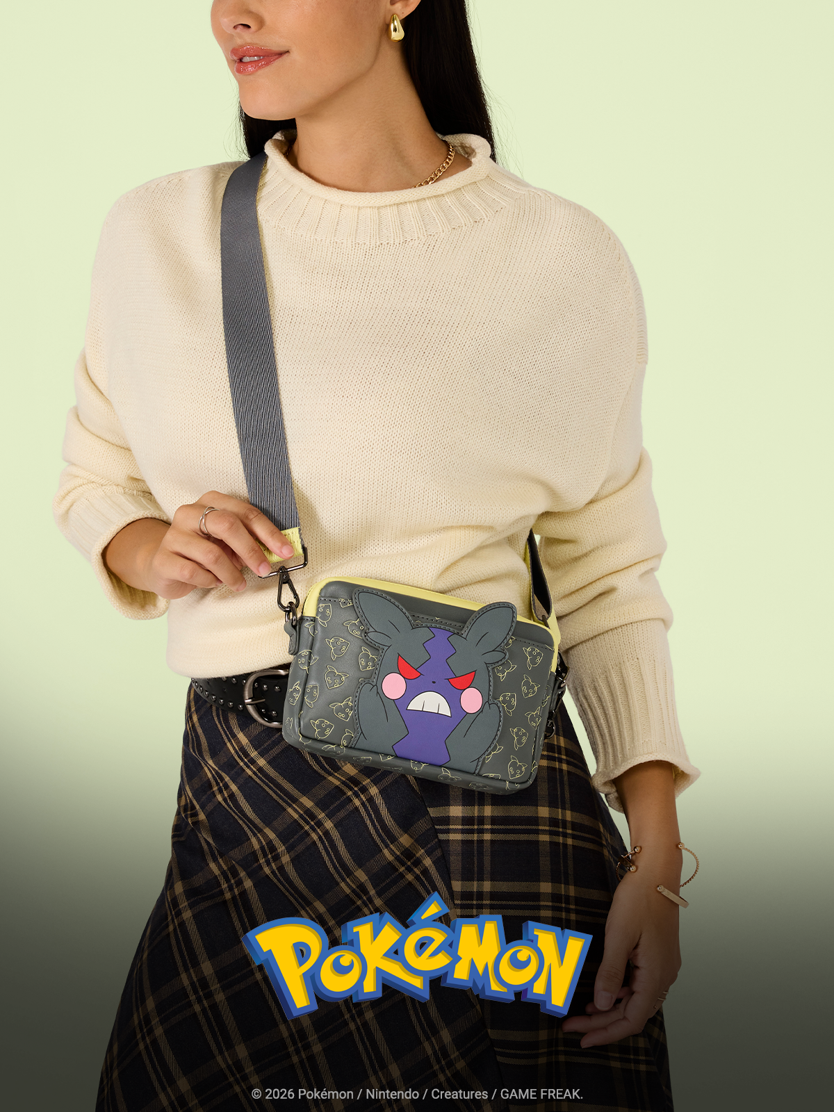 Yellow background with model wearing Loungefly Pokemon Crossbody Bag