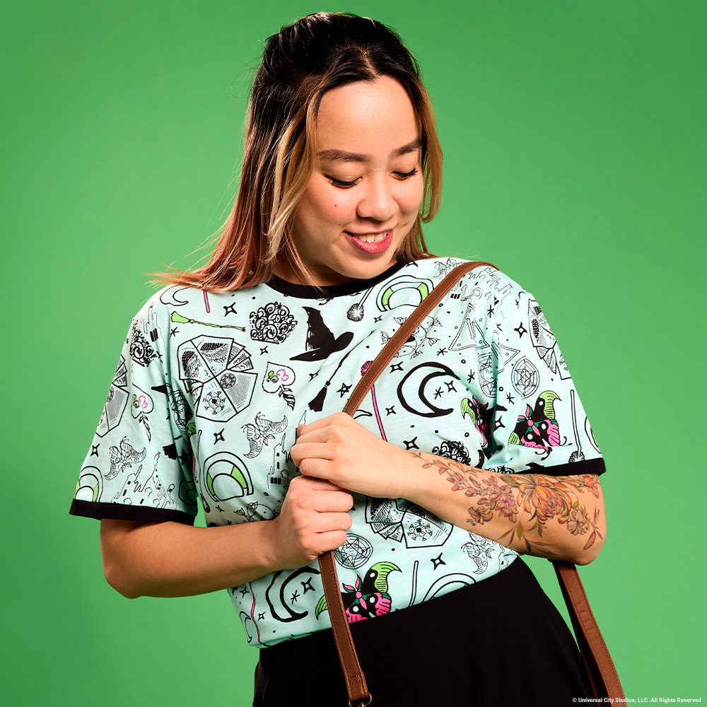 Green background with model wearing Loungefly Wicked apparel