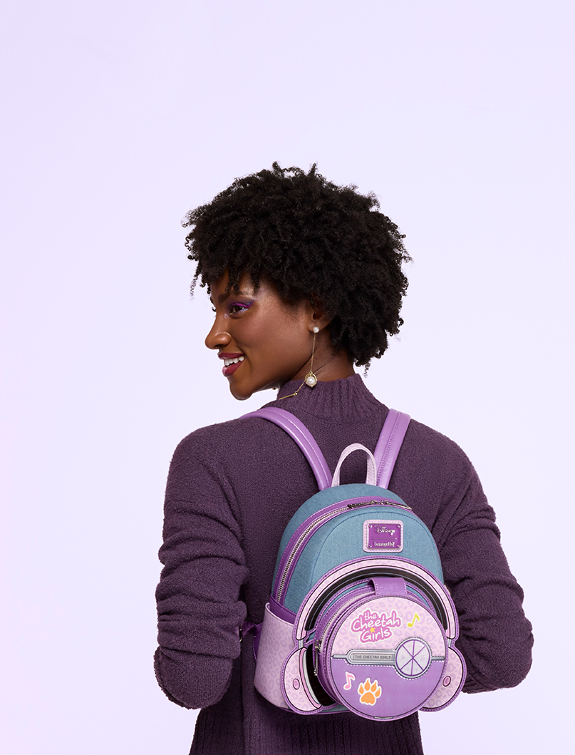 Purple background with model showcasing Loungefly Disney Cheetah Girls collection