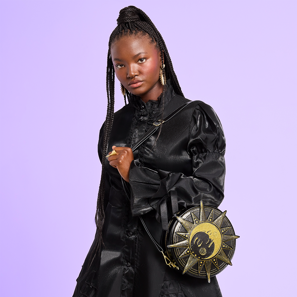 Purple background with model showcasing Loungefly Celestial collection bag