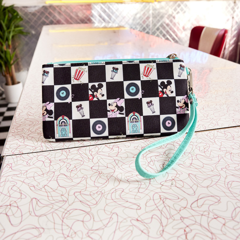 Image of the Mickey and Minnie Date Night Diner Checkered All-Over Print Nylon Zipper Pouch Wristlet sitting on a diner table 