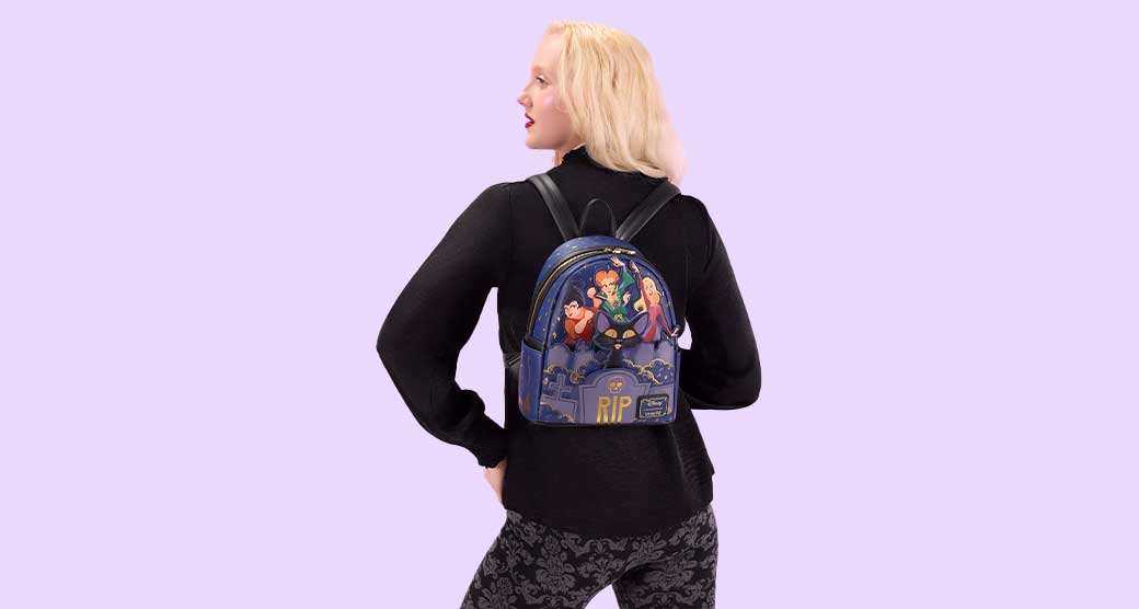 Light Blue background with model showcasing Loungefly Disney Mickey & Friends Halloween collection