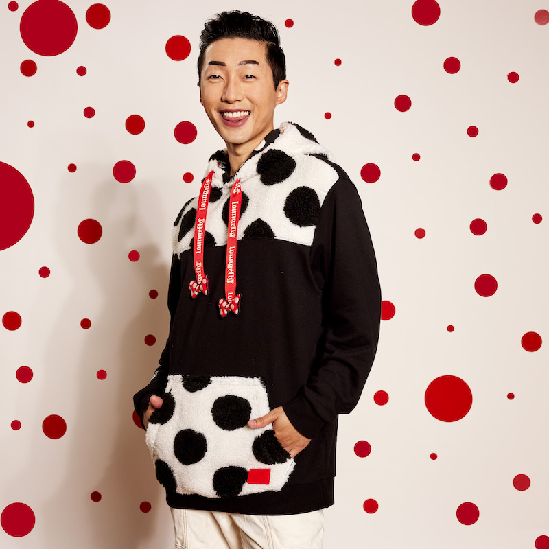 Image of man wearing the Minnie Mouse Rocks the Dots Classic Sherpa Hoodie against a white background with red polka dots 