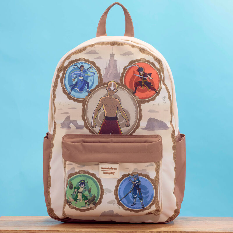 Loungefly Avatar: The Last Airbender full-size backpack featuring Aang, Katara, Zuko, Toph, and Sokka. The bag sits on a wooden table against a blue background. 