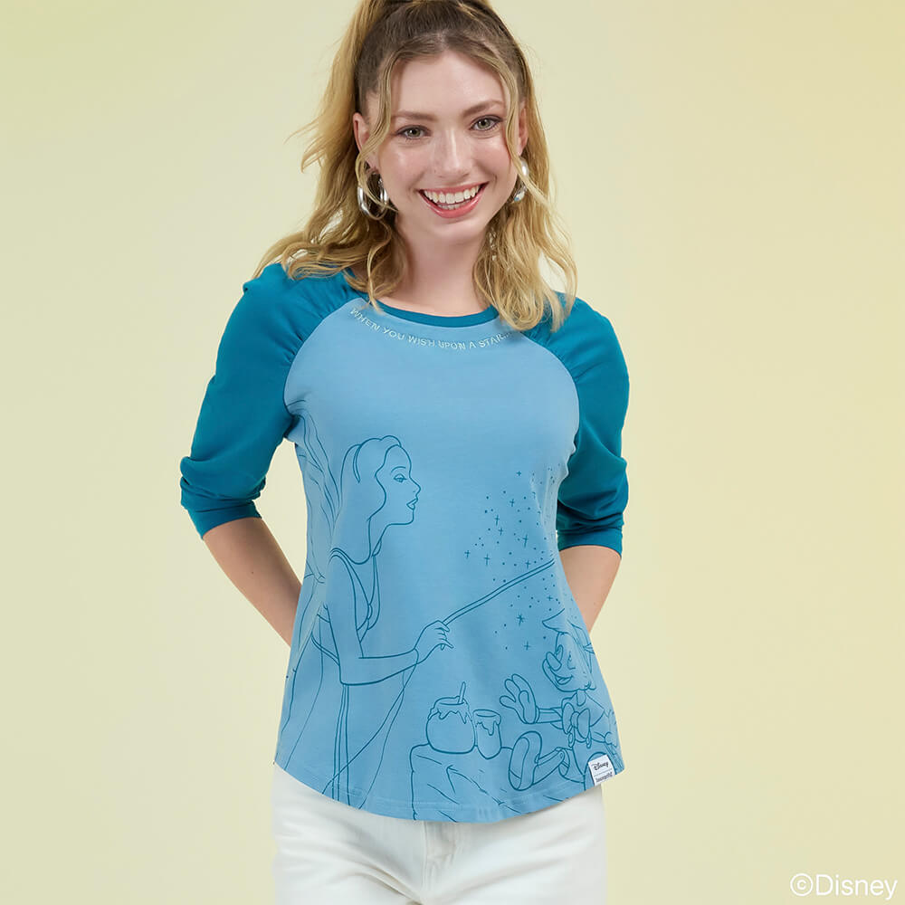 Light Green background with model showcasing Loungefly May Disney Pinocchio apparel