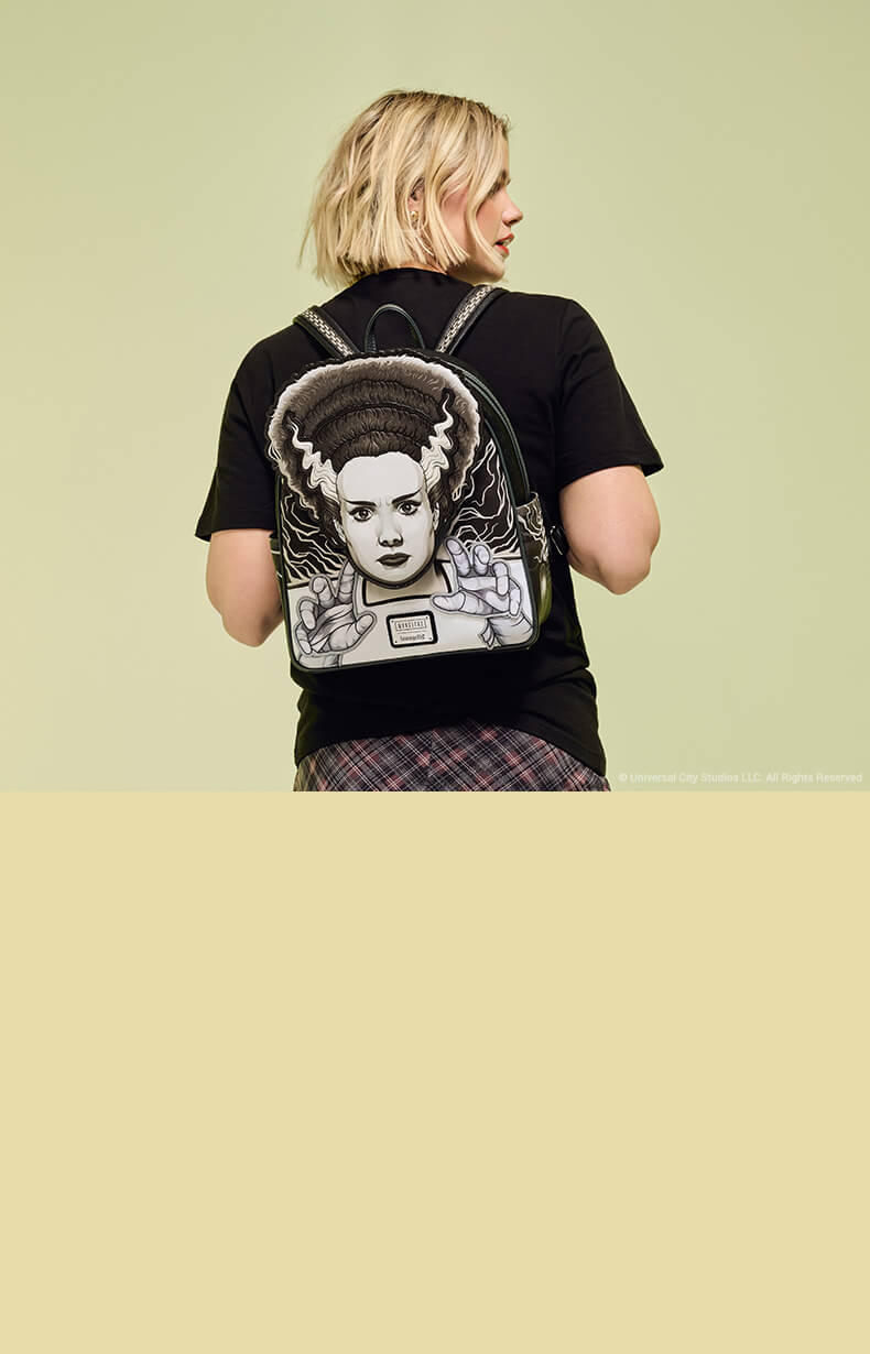 Yellow Green gradient background with model showcasing Loungefly Universal Monsters Bride of Frankenstein exclusive mini backpack