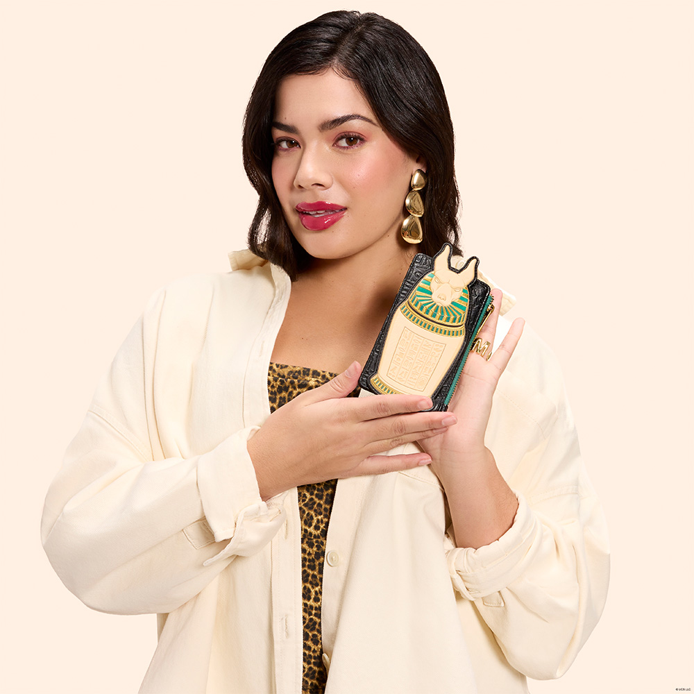 Beige background with model showcasing Loungefly The Mummy wallet