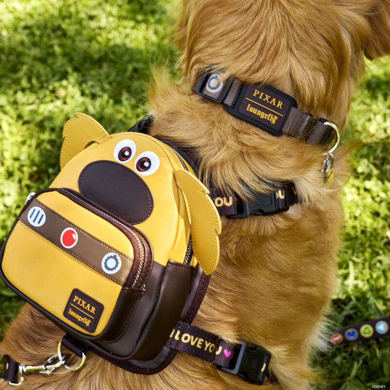Golden retriever facing away from camera wearing the Pixar Up Dug Dog Harness, featuring Dug from Up in appliqué detail