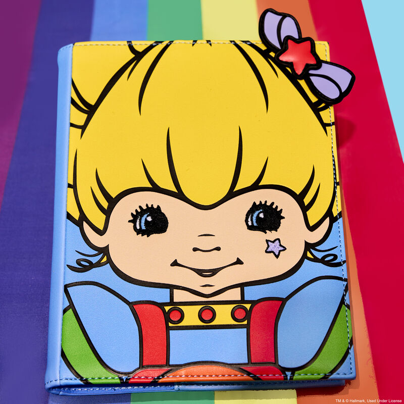 Rainbow Brite journal laying against a rainbow background, featuring Rainbow Brite on the cover with appliqué and embroidered details.