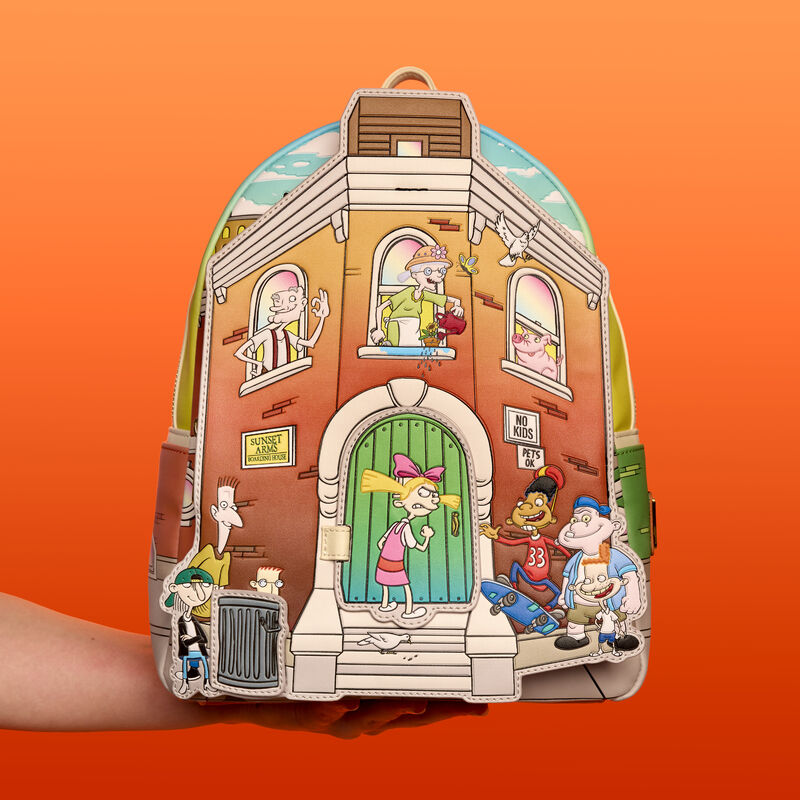 Arm holding up the Loungefly Hey Arnold mini backpack, featuring Sunset Arms Boarding House with a variety of characters from the show on the front. The bag appears in front of an orange background. 