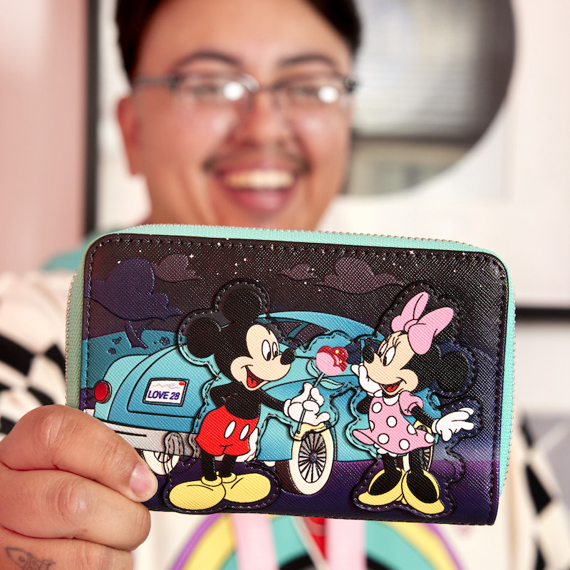 Man holding up the Mickey and Minnie Date Night Drive-In wallet to the camera 