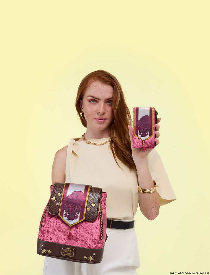 Yellow background with model showcasing Loungefly July Warner Brothers Harry Potter Banner collection featuring Gryffindor