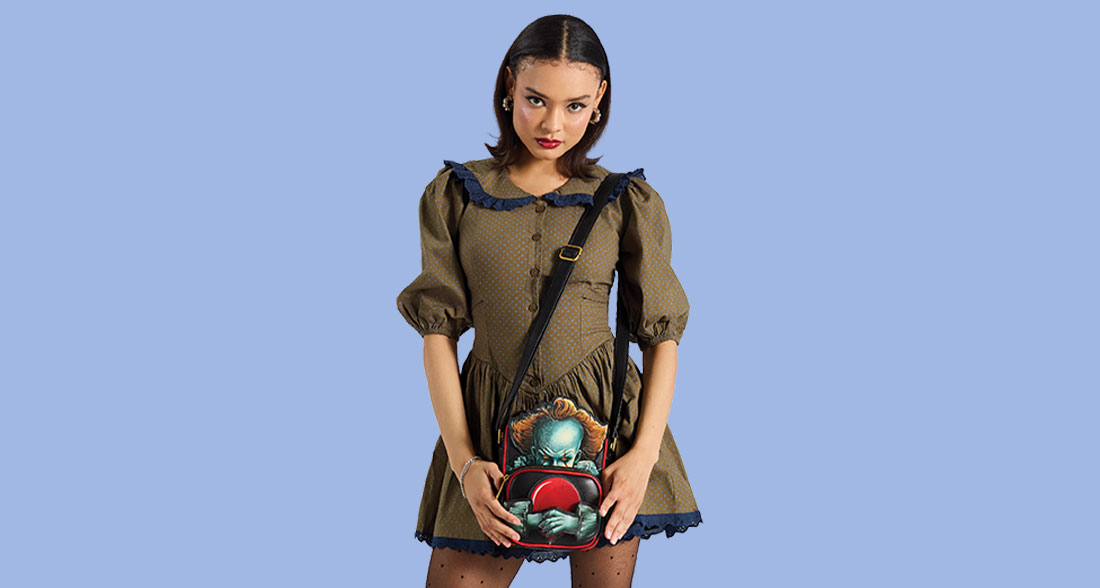 Model showcasing Loungefly Warner Brothers IT Crossbuddies Bag