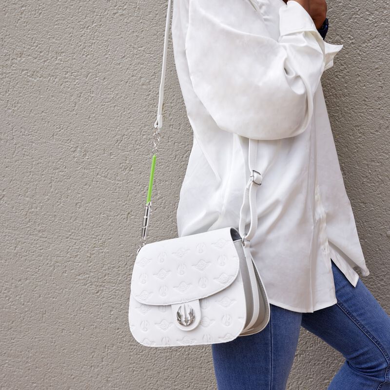 Image of a person wearing a white shirt and blue jeans carrying the Star Wars Light Side Saber Strap Crossbody over their shoulder