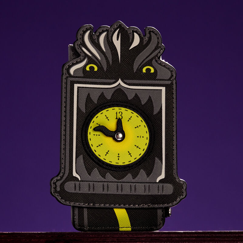 Loungefly card holder featuring the grandfather clock from the Haunted Mansion with glowing details. It sits against a purple background. 