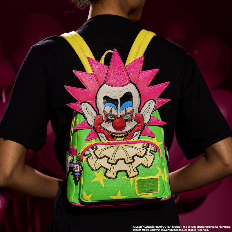 Person facing away from camera wearing the Loungefly Killer Klowns Spikey mini backpack, featuring Spikey in appliqué detail on the front of the bag. 