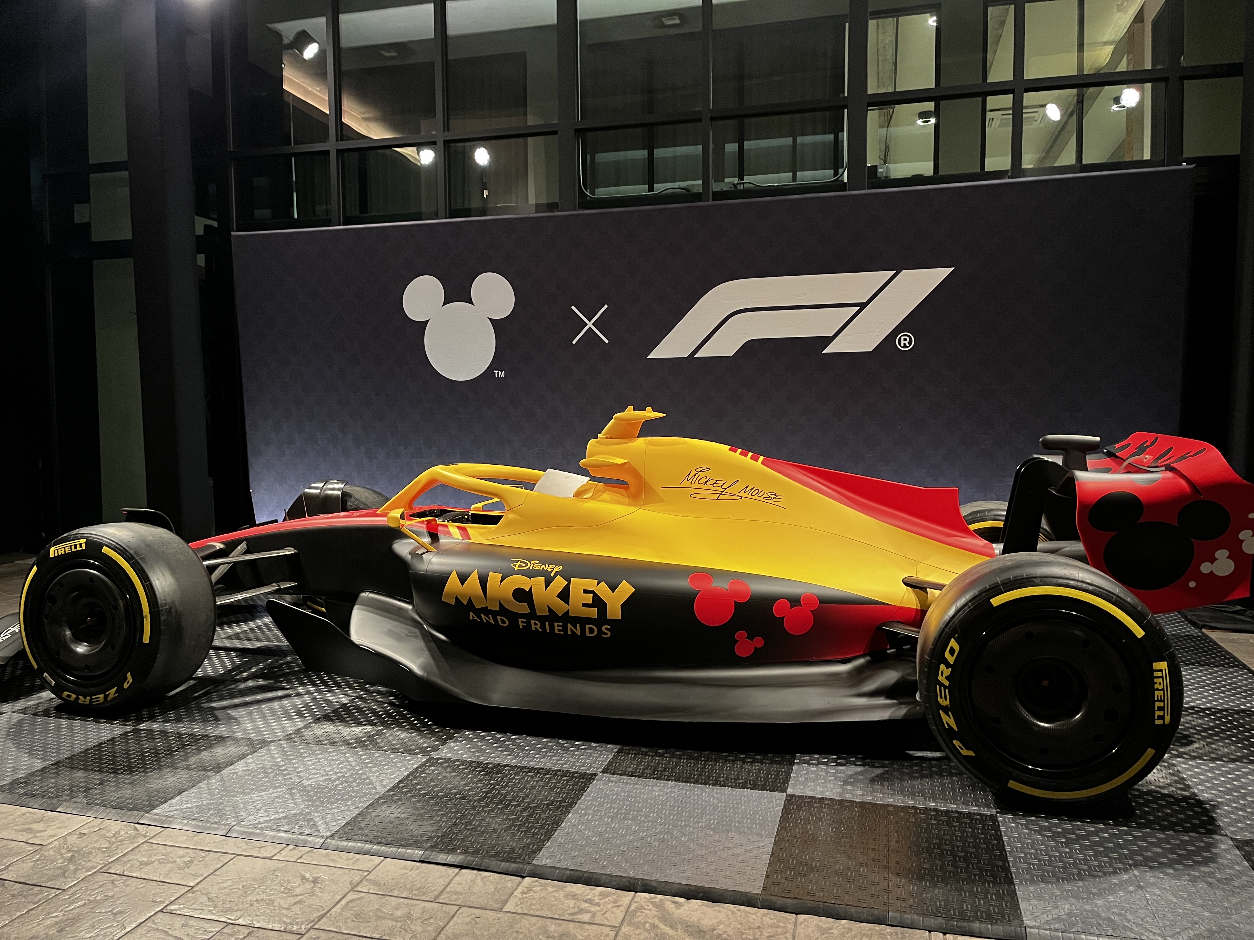 Image of Mickey-themed F1 racer that's red, yellow, and black.