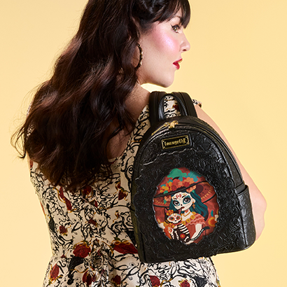 Yellow background with model showcasing Loungefly Branded Dia de los Muertos Mini Backpack