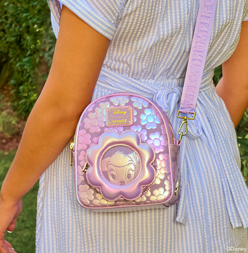 Girl in dress showing Loungefly Disney Bambi crossbody