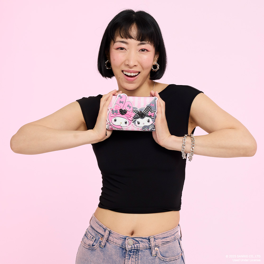 Pink background with model showcasing Loungefly Sanrio My Melody and Kuromi wallet