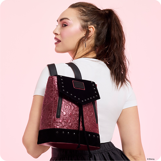 Light Red background with model showcasing Loungefly Disney Villains backpack