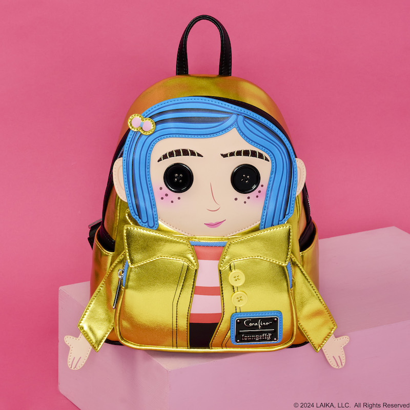 Loungefly Coraline cosplay mini backpack sitting against a pink background. Coraline comes to life in appliqué detail with buttons for eyes and 3D arms. 