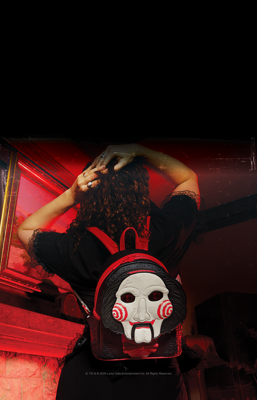Dark background with lifestyle image of model wearing Loungefly Exclusive Saw Billy the Puppet Mini Backpack