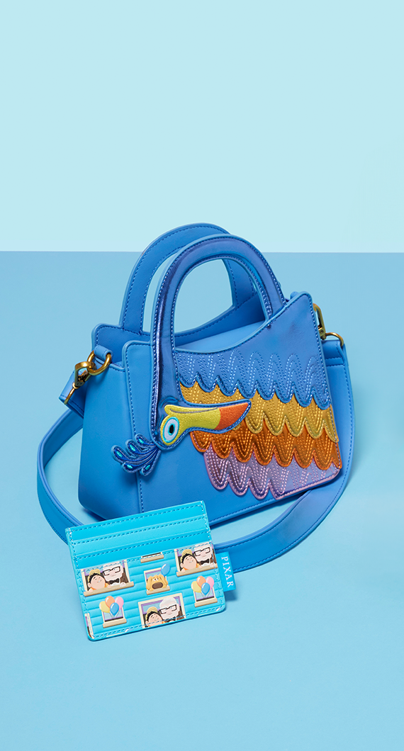 Blue product background featuring Loungefly Disney Pixar UP crossbody bag and wallet