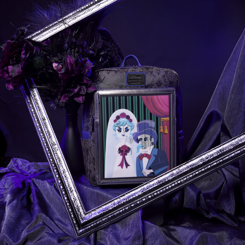 Image of a dark purple background with the Loungefly Haunted Mansion The Black Widow Bride Portrait Lenticular Mini Backpack sitting in a silver frame 