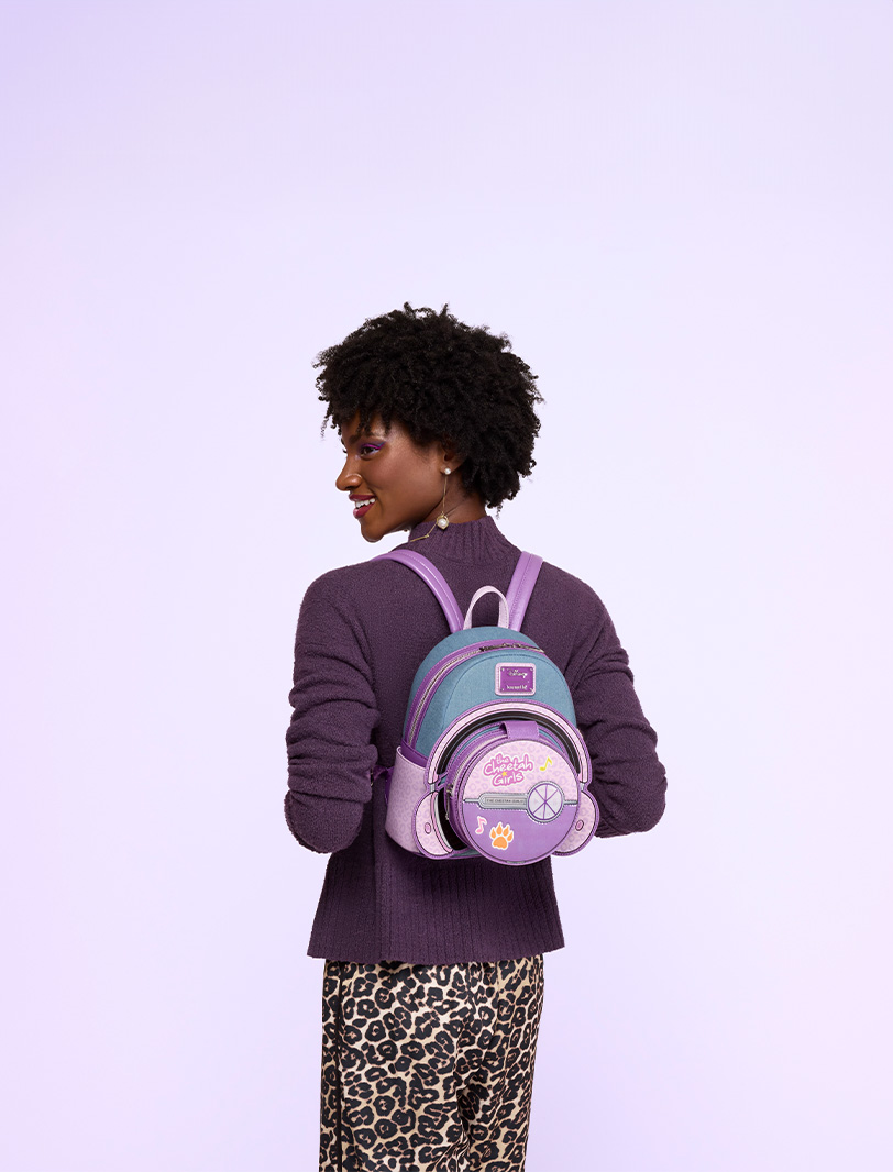Purple background with model showcasing Loungefly Disney The Cheetah Girls mini backpack