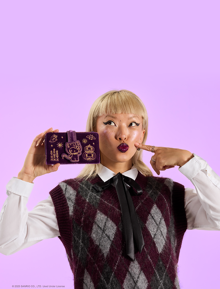 Purple background with model showcasing Loungefly August Sanrio Velvet Halloween exclusives