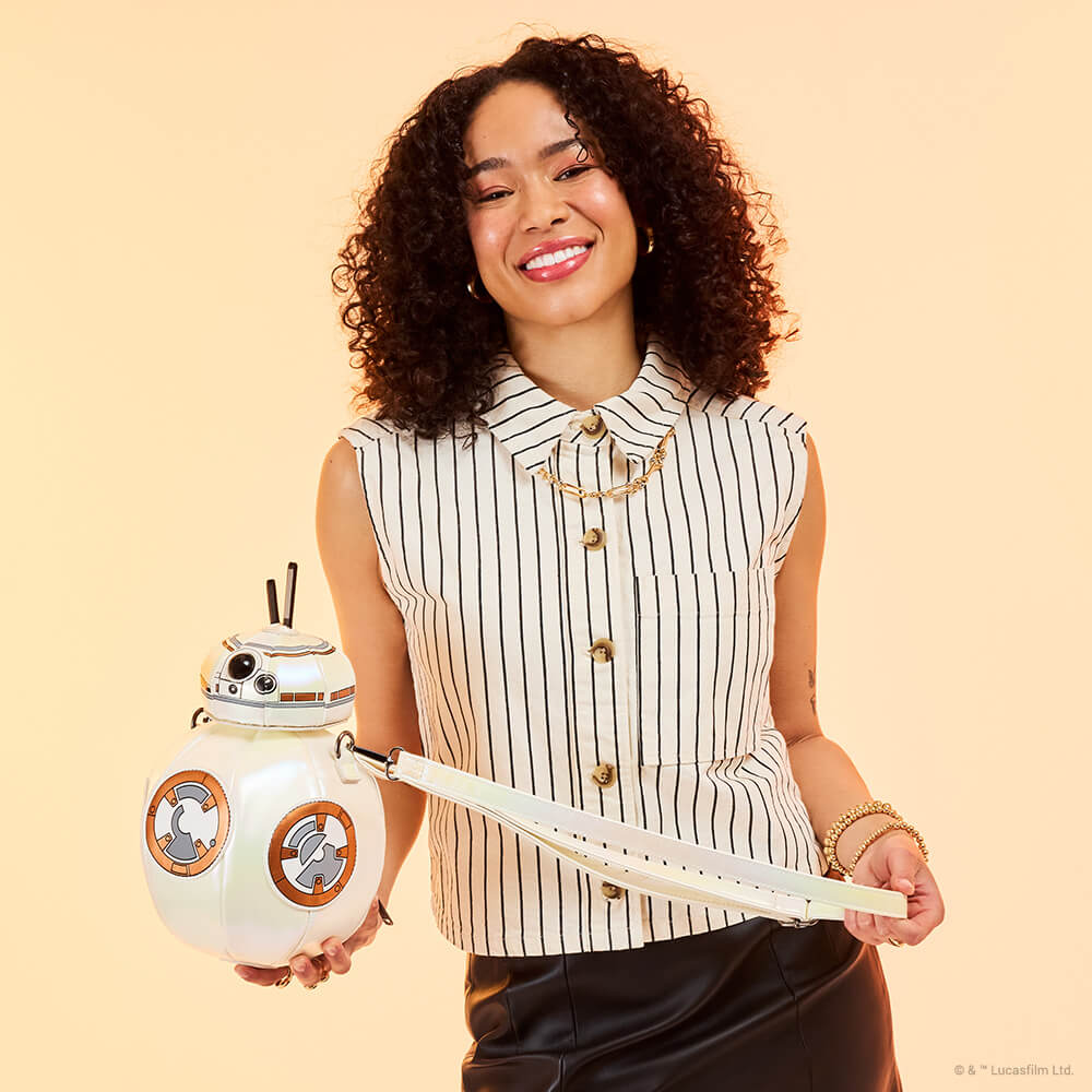 Tan background with model showcasing Loungefly Star Wars: The Force Awakens BB-8 Figural Crossbody Bag