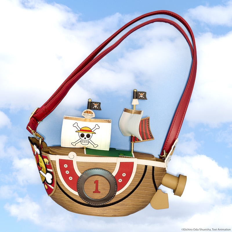 Loungefly One Piece figural crossbody bag in the shape of the Thousand Sunny with 3D sails and masts. The bag sits against a light blue cloudy sky background. 