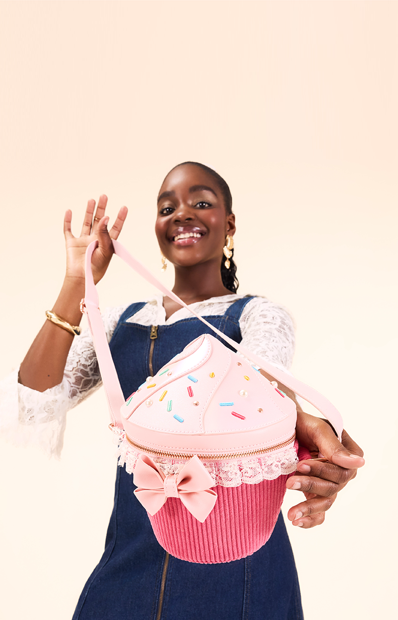 Tan background with model showcasing Loungefly Branded Figural cupcake crossbody