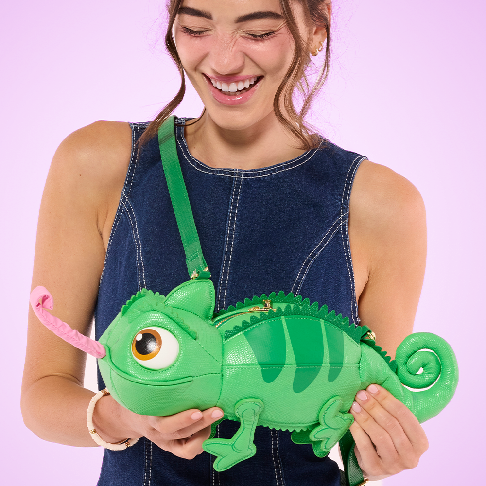 Purple background with model holding Loungefly Disney Tangled Pascal Figural Crossbody bag
