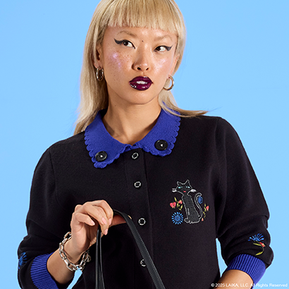 Blue background with model wearing Loungefly Coraline cardigan